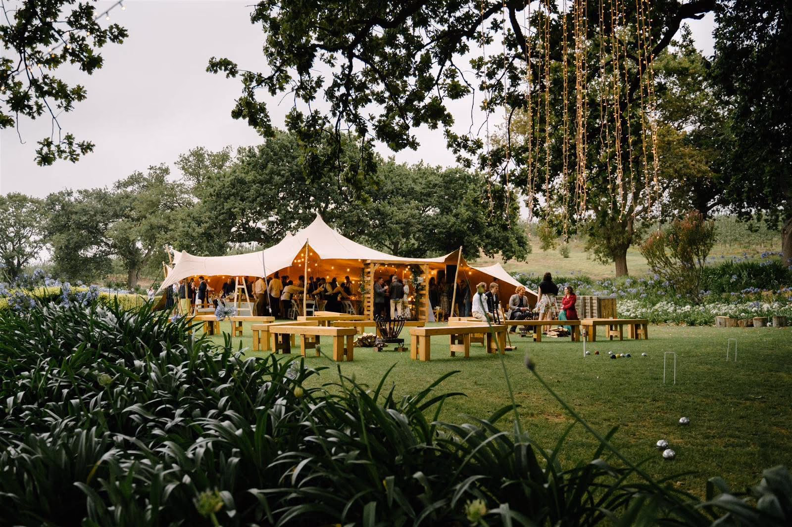 A stretch marquee glowing among the Nidderdale gardens